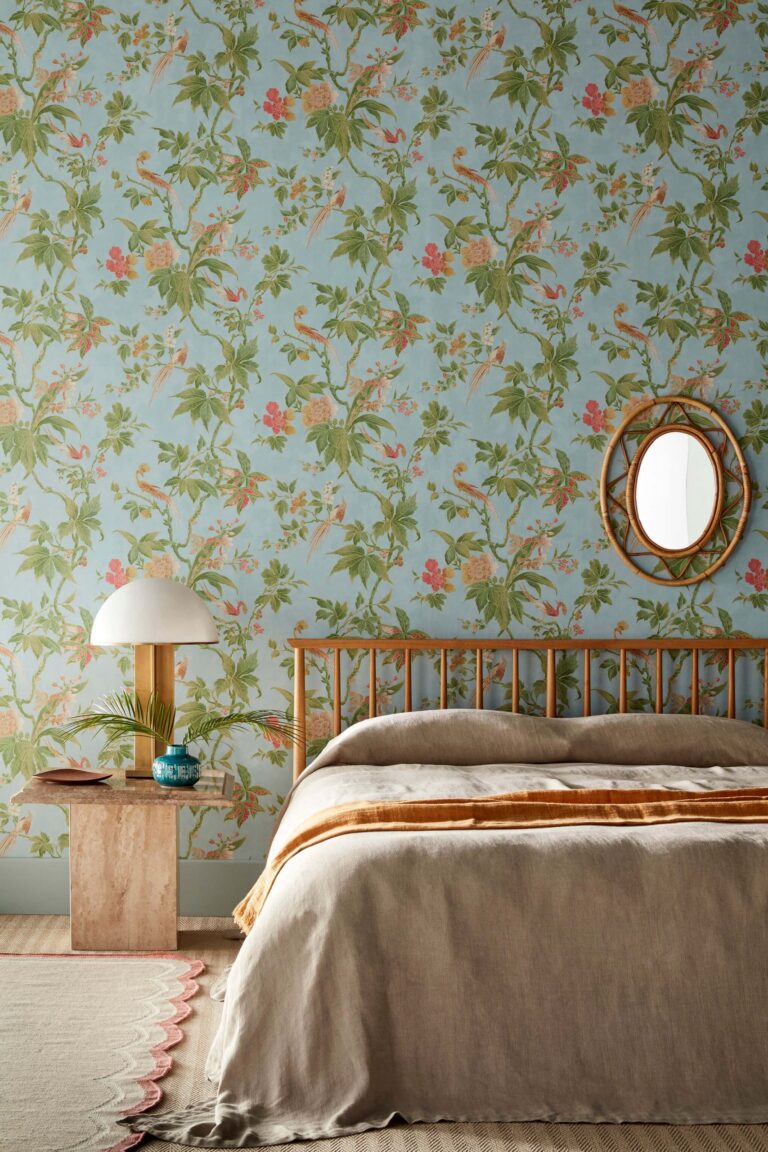 Camera da letto con carta da parati floreale su fondo azzurro